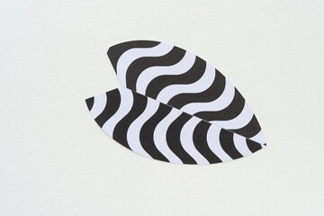 Poster - isolated paper shape composed of two pieces with wavy stripes on blank paper