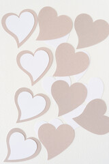 Wall Mural - machine-cut beige and white paper hearts on blank paper