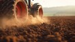 Tractor kicking up dust and sand on the farm field. Agriculture scene.
