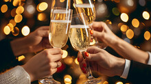 Happy Friends Having Fun And Toasting Sparkling Wine Glasses Close-up Against Golden Bokeh Lights Background. Christmas Celebration