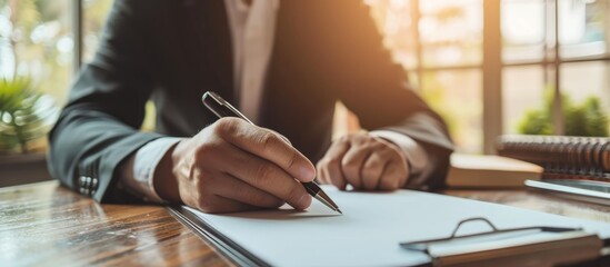 Cropped hands of businessman holding pen on white paper for customization.