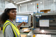 © chachamp - African American businesswoman working with use monitor control machine at Kraft paper factory