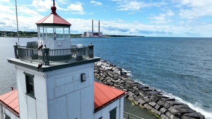 Wall Mural - Lighthouse in Oswego New York close up on Lake Ontario at the mouth of Oswego River and harbor in small town on the coast of the Great Lake Historic Architecture Harbor beacon for boaters