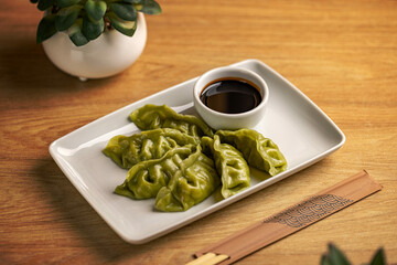 Sticker - Platter of steamed Chinese spinach filling dumplings