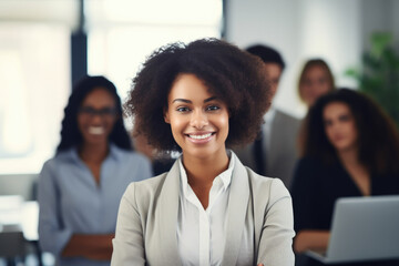 Photo of young office worker woman smiling at camera in front of people in suits