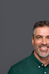 Wall Mural - Happy middle aged business man entrepreneur, smiling mature professional executive manager, confident businessman leader investor wearing green shirt isolated on gray, half face cropped portrait.