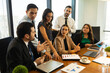 © AntonioDiaz - Group of businesspeople having a discussion in a meeting room and looking serious