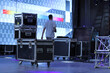 Technicians working setting up a stage with giant LED screens. Drawers for carrying equipment for shows and setting up stages. Trunks for technical equipment for events.  Technical setup of stage.
