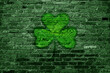 St.Patrick 's Day. Green brick wall with clover sign.
