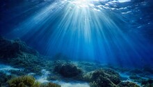 Abstract Image Of Tropical Underwater Dark Blue Deep Ocean Wide Nature Background With Rays Of Sunlight