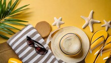 Beach Accessories On The Yellow Background Sunglasses Towel Flip Flops And Striped Hat Summer Is Coming Concept