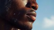 Shining. Detailed texture of human skin. Close up of young african-american male body surface like landscape with the sky on background. Skincare, bodycare, healthcare, inspiration, fantasy artwork. 
