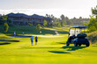 © Chebix - A day at a golf course, nice weather, nice course. Golf cart in front, golfers walking to the green.