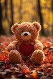 Fototapeta  - Cozy Autumnal Teddy Bear Scene - Holding Red Heart, Golden Backlight, Valentine's Day Concept
