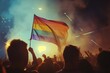A vibrant sea of diverse individuals proudly wave a colorful rainbow flag against the backdrop of a clear blue sky at an outdoor music festival, celebrating unity and acceptance at this lively and sp