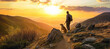 Hiker and dog on a mountain trail watch the sunset