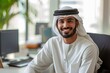smiling emirati arab at office wearing kandura