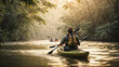 Unrecognizable young man from behind and carefree in kayak enjoying nature in a river in the jungle at sunset near a waterfall, with sunrise. Beauty girl outdoors. Concept of freedom and adventure 