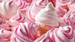  a pile of pink and white cupcakes with white frosting on top of each cupcake with a cone sticking out of the top of the cupcake.