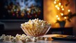 Popcorn in a glass bowl in front of the TV in the home interior with copy space.