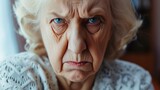 Fototapeta  - Angry belligerent senior woman looking at the camera