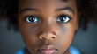 Close-up of a young black child with expressive eyes, symbolizing innocence and the importance of civil rights.