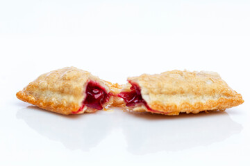 McDonald's cherry pie. Delicious garbage food and a quick pie. White background with reflection. Close-up. White background with reflection.