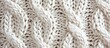 White cable stitch knitting background closeup.