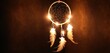  a light up dream catcher with feathers hanging from it's sides on a dark background with light coming from the top of the dream catcher and the bottom of the dream catcher.