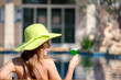 © freebird7977 - Summer time and Vacations. Women lifestyle relaxing and drinking juice orange so happy in luxury swimming pool sunbath, summer day at the beach resort in the hotel. Summer Concept