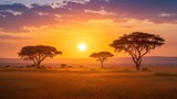 Fototapeta Sawanna -  the sun is setting over the plains with trees in the foreground and a field of grass in the foreground, with a few giraffes in the foreground.