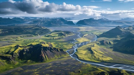 Wall Mural -  an aerial view of a river running through a valley surrounded by mountains under a blue sky with white clouds and a few white puffy scattered