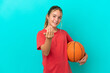 Little caucasian girl playing basketball isolated on blue background inviting to come with hand. Happy that you came