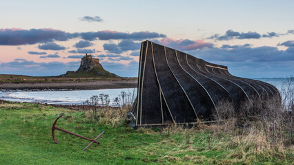 Wall Mural - Stunning dramatic landscape image of Lindisfarne, Holy Island in Northumberland England during Winter