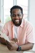 © cocorattanakorn - Smiling Young African Businessman with paper sheet is working and meeting at workspace in modern office. Business and people concept