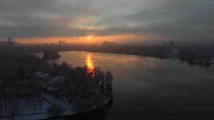 Wall Mural - Winter sunrise in Bucharest. 4K aerial video with a beautiful sunrise landscape in Bucharest, view to Herastrau Park and north part of the city with buildings skyline. Travel to Romania.