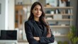 © Hope - Business portrait. Charming successful positive indian or arabian business woman, secretary, ceo manager dressed in a stylish suit standing in a modern creative office, looking and smiling at camera