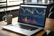 Laptop with stock market data on screen. Financial and trading concept.
