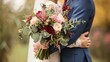 close up of a bride and groom hugging with wedding bouquet in focus     