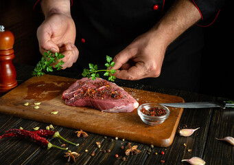 Wall Mural - The chef adds aromatic parsley to the veal meat before grilling. Meat diet concept