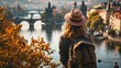 Back view of a young girl watching a fantastic view of bridges over Vltava River with historic buildings in the city of Prague, Czech Republic in Europe.