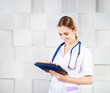 © Dasha Petrenko - Female doctor with tablet computer