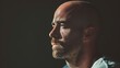 © พงศ์พล วันดี - Man hair loss confidently embracing his baldness against a dark background.