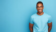 African american man waring blue t-shirt and glasses isolated on blue background