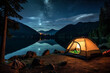 A tent camping besides a beautiful lake