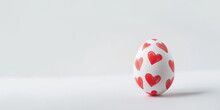 One Easter Egg With Hand Painted Red Heart Pattern On A White Background With Copy Space For Text. White Egg With Red Hearts. Happy Easter Concept. Horizontal Banner, Poster