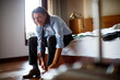 © Marko Geber - Mature businessman getting ready to go to work in a hotel room
