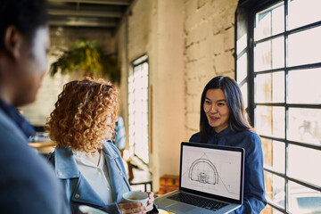 Wall Mural - Young colleagues discussing architectural plans in the office