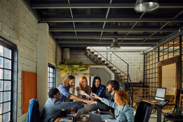 Wall Mural - Multicultural team working together in modern office space