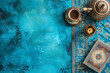 Ramadan holiday banner with candle and teapot. Top view on blue background with copy space